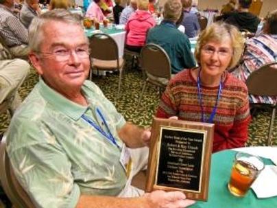 Couple Seated Holding an Award