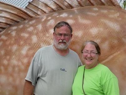 Couple Standing Together With Arms Around One Another