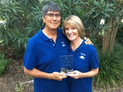 Couple Holding an Award